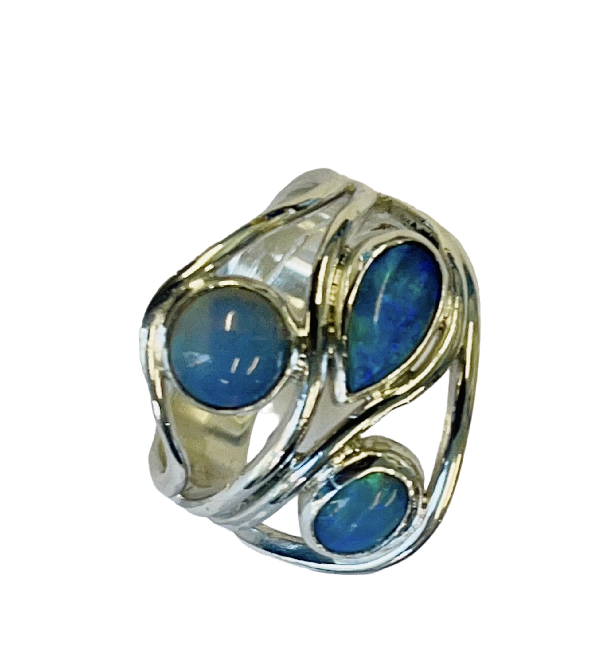 Silver dress ring with three bezel-set opals ,  a round Welo opal at left flashing electric blue, a pear-cut black opal at top right and a smaller round black opal at lower right, each rimmed in yellow gold on a textured silver shank