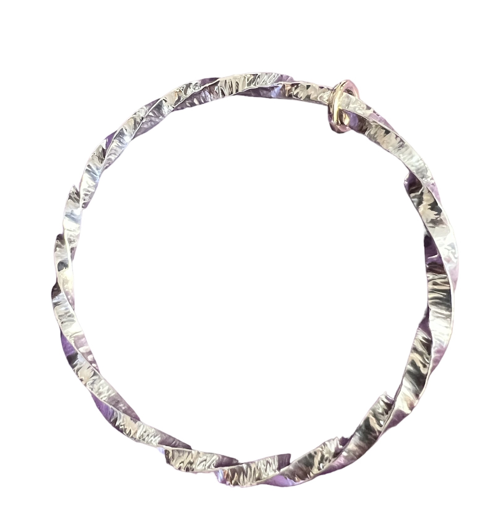 Silver bangle hand-twisted from hammer-textured square wire with a yellow-gold accent bead at one terminal