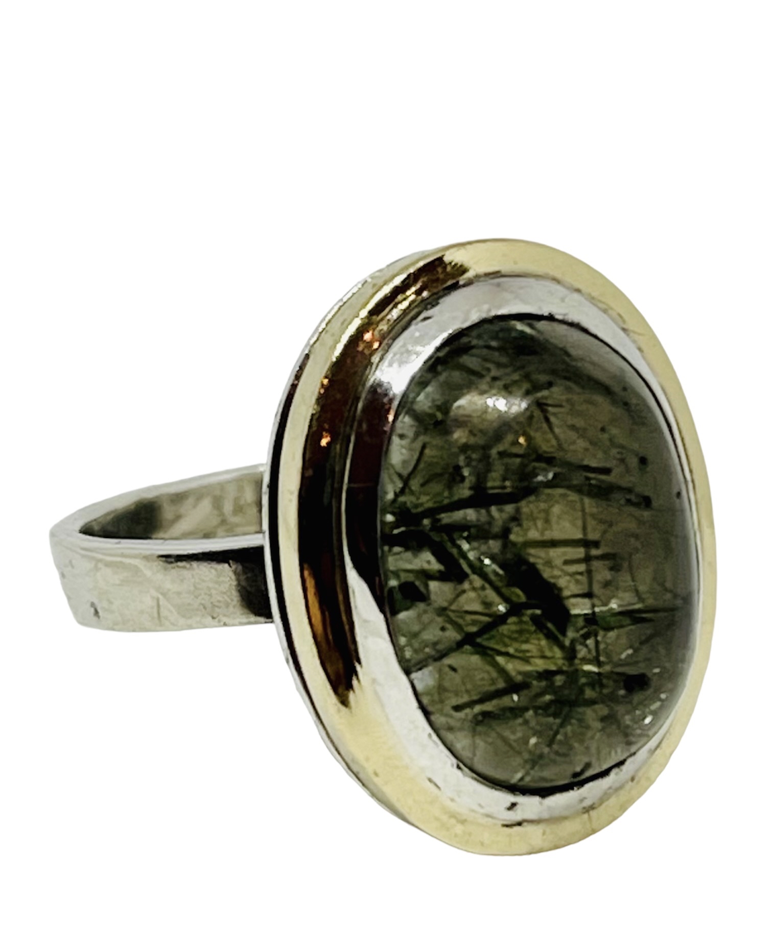 Oval cabochon rutilated quartz in a silver bezel rimmed in yellow gold on a hammered silver band